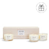 NEOM candle set with three candles in front of a beige box on a white background