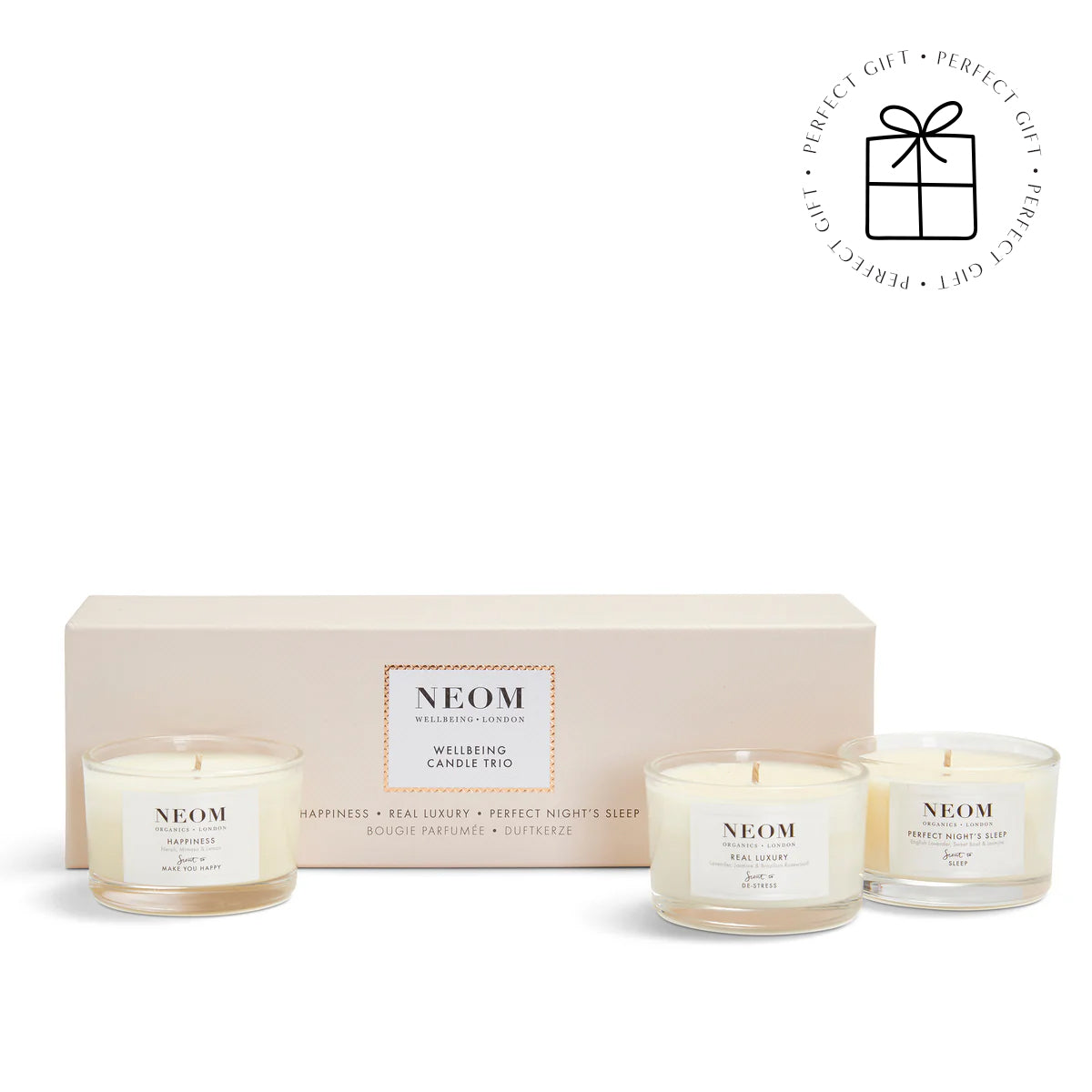 NEOM candle set with three candles in front of a beige box on a white background