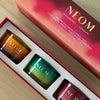 Close-up of NEOM Winter Wellbeing Candle Trio featuring Cosy Nights, Perfect Peace, and Christmas Wish candles.