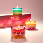 NEOM candles with a pink box in the background